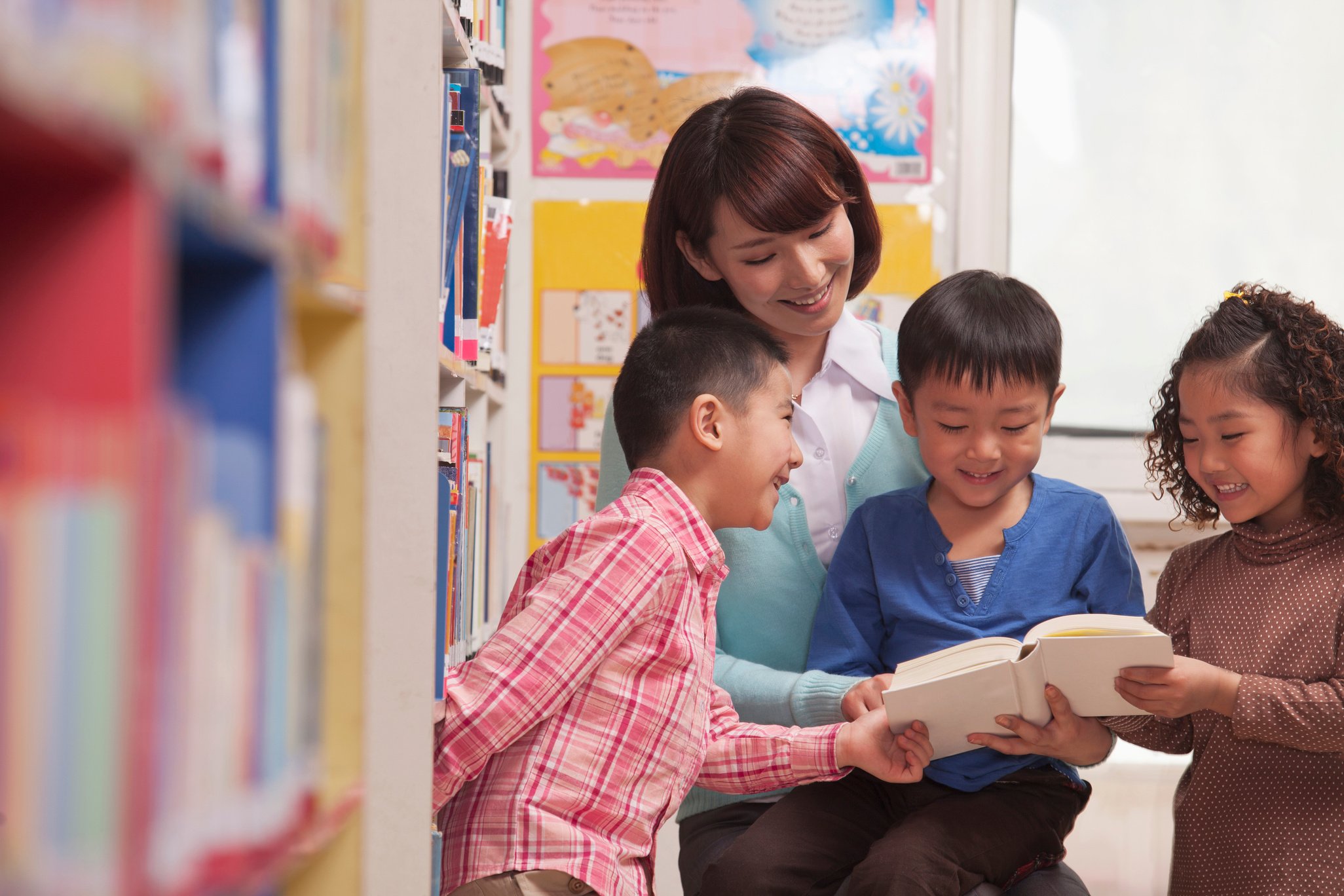 Chinese teacher reading book to students